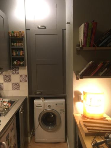 a kitchen with a washing machine in a kitchen at Beautiful Old property in Bordeaux Center in Bordeaux