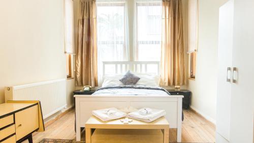 a bedroom with a bed with a table and a window at Historical Ottoman Manor in İzmir