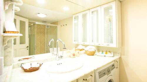 a bathroom with a sink and a large mirror at Historical Ottoman Manor in İzmir