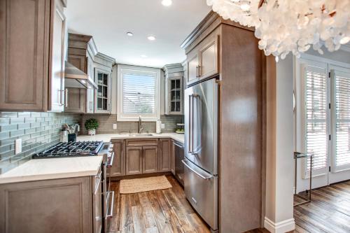 a kitchen with wooden cabinets and a stainless steel refrigerator at Sonoma Bungalows in Sonoma