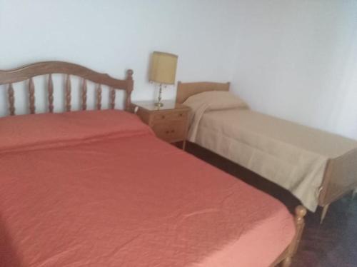 two beds sitting next to each other in a bedroom at Departamento céntrico Tupungato in Tupungato