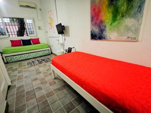 a bedroom with two beds and a painting on the wall at Apartamento Las Orquideas in Mendoza