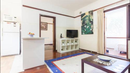 a living room with a refrigerator and a table at B4 Crawley Apartment 1 BRM & Sleepout near UWA in Perth