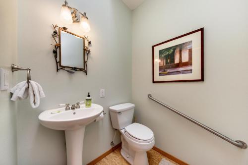a bathroom with a white toilet and a sink at The Cliff House in Cloverdale