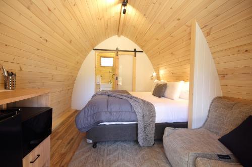 ein Schlafzimmer mit einem Bett in einem Holzzimmer in der Unterkunft BIG4 Bendigo Park Lane Holiday Park in Bendigo