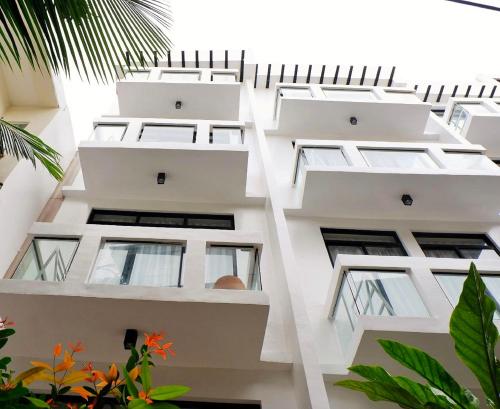 an external view of a white building with windows at Luxx Boutique Boracay in Boracay