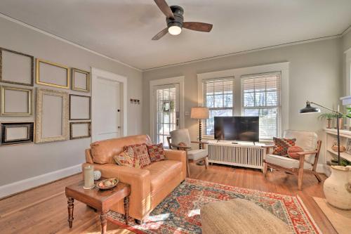 a living room with a couch and a tv at Vintage Chic Cottage Less Than 1 Mile to UNC Greensboro! in Greensboro