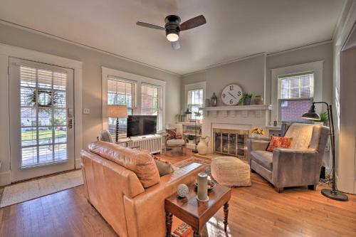 a living room with a couch and a fireplace at Vintage Chic Cottage Less Than 1 Mile to UNC Greensboro! in Greensboro