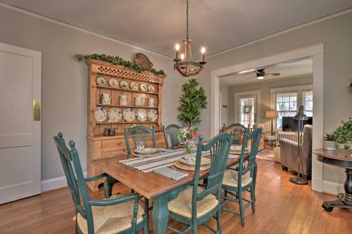 a dining room with a wooden table and chairs at Vintage Chic Cottage Less Than 1 Mile to UNC Greensboro! in Greensboro