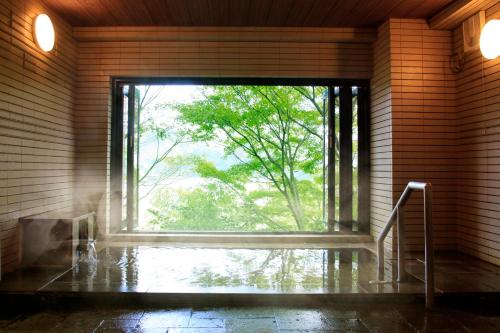 a large window in a room with a tree outside at Yutorelo-an ANNEX in Hakone