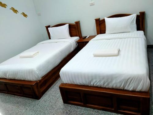 Łóżko lub łóżka w pokoju w obiekcie โรงแรมคูณคีม