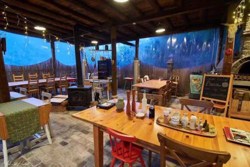 a large room with tables and chairs and a large window at Moganshan Solvang Village Boutique Hotel in Deqing
