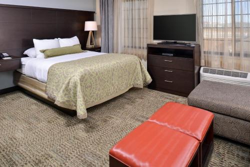 A bed or beds in a room at Staybridge Suites Rochester, an IHG Hotel