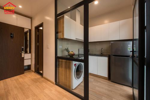 a kitchen with a washing machine in a room at Merry House Imperia in Hai Phong