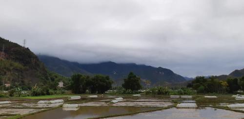 a view of a river with mountains in the background at Your home Mai Chau in Mai Chau