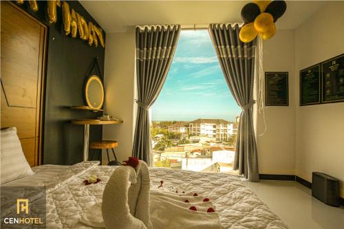 a bedroom with a bed and a window with a view at Cen Hotel in Vung Tau