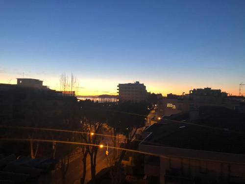 a view of a city skyline at sunset at Hotel Garisenda B&B - in Centro a Riccione - in Riccione