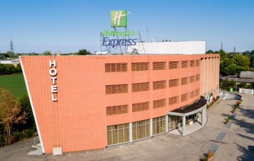 
a large building with a sign on the side of it at Holiday Inn Express Parma, an IHG Hotel in Parma
