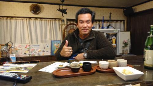 a man sitting at a table giving a thumbs up at Live Cafe Hisui no Umi in Itoigawa