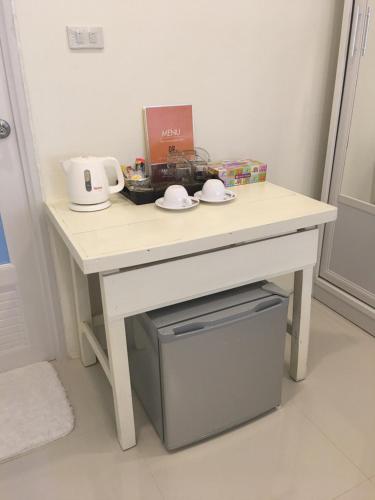 a white table with a counter top with a drawer at Naraya Homestay in San Pa Tong