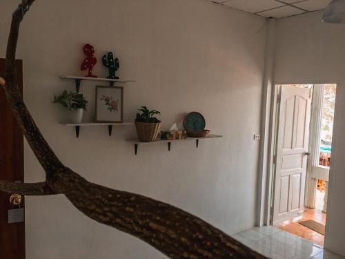 a room with shelves on the wall and a door at Take A Rest At Nakhon Phanom in Nakhon Phanom