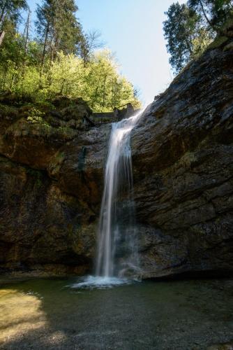 a waterfall on the side of a rock wall at Hotel-Gasthof Mauthäusl in Weißbach