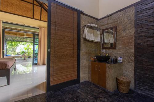 a bathroom with a sink and a mirror at Villa Latebra in Lovina