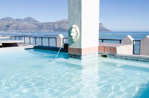 a swimming pool with the ocean in the background at Strand Pavilion in Strand