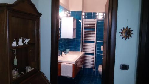NervianoにあるStorica Quercia B&Bの青いタイル張りの壁、洗面台付きのバスルーム