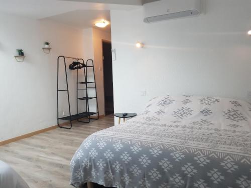 a bedroom with a bed and a ladder in it at Le Saint Jean in Barbentane
