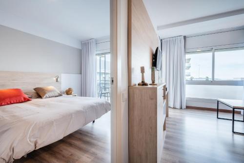 Ένα ή περισσότερα κρεβάτια σε δωμάτιο στο Apartamentos Astoria