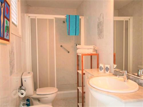 a bathroom with a toilet and a sink and a shower at APARTAMENTO ISAMAR in Calella