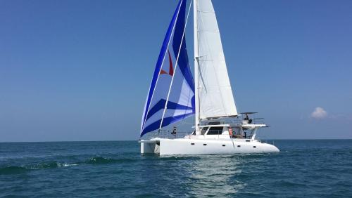 a white sail boat in the ocean on the water at Villa Yuvin in Matara