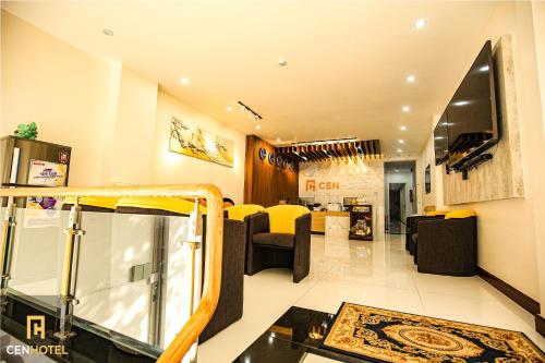 a living room with a couch and chairs in a room at Cen Hotel in Vung Tau