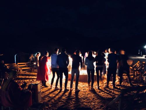 a group of people standing in front of a fire at Hostel Amour d'auberge in Marrakech