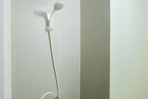 a shower with a shower head in a bathroom at Exclusive 2BR Bogorienze Resort Bogor near The Jungle By Travelio in Bogor