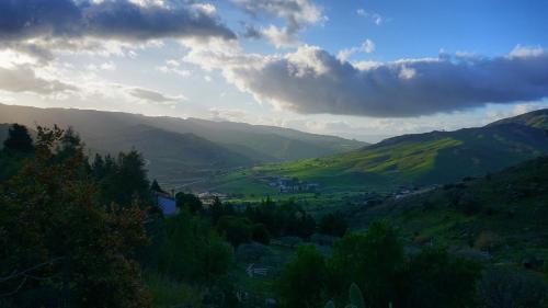 a view of a valley with mountains in the distance at Casetta Pizziddu in San Giovanni Gemini