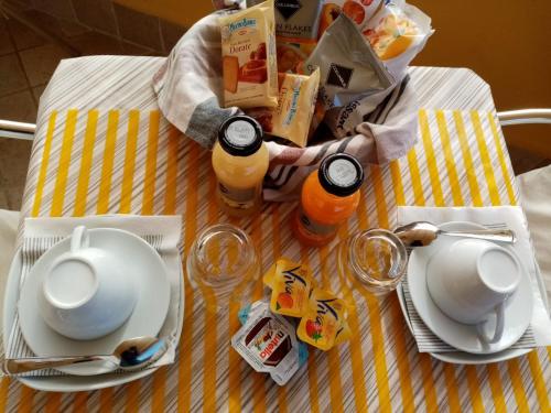 a table with plates of food and drinks on it at B&B La Cupella in Monterotondo