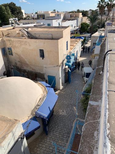 an overhead view of a street with blue benches and buildings at Dar Lola Djerba in Houmt Souk