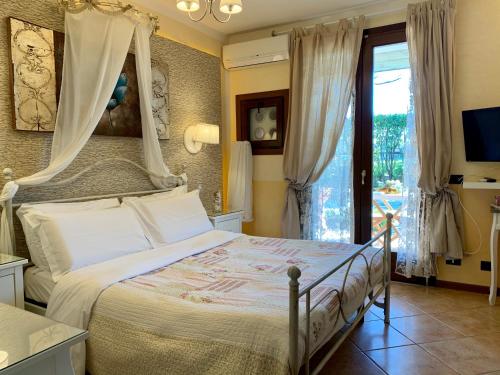 a bedroom with a bed with a canopy at B&B Garda 4U in Desenzano del Garda