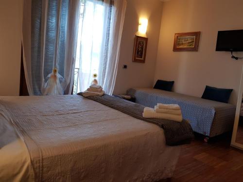 a bedroom with two beds and a window at Aurelia Garden Gold B&B in Rome