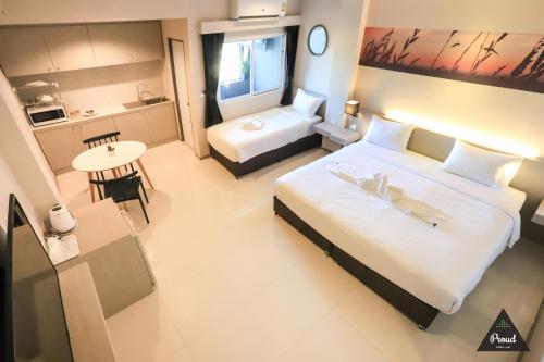 a hotel room with a large bed and a bathroom at Proud Khaoyai in Pak Chong