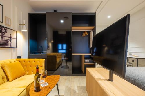 a living room with a large flat screen tv at Barbarossa Suites Plaza de España in Merida