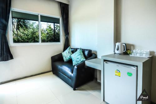 a living room with a chair and a window at Proud Khaoyai in Pak Chong