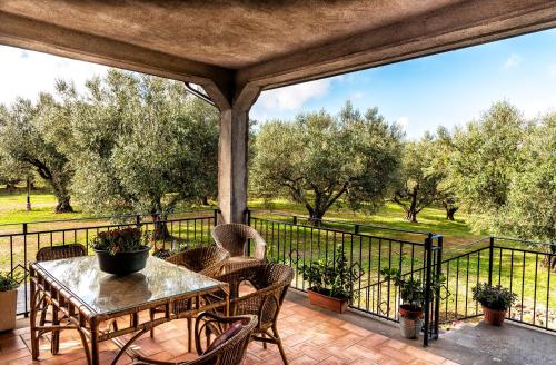 a patio with a table and chairs on a balcony at Poggio della Stella in Blera