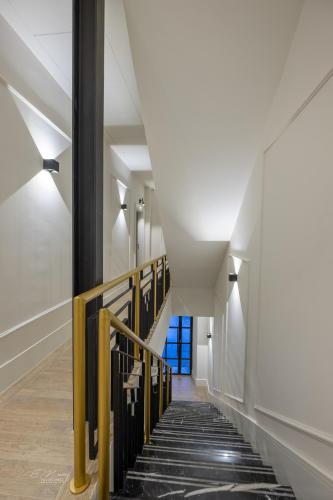 a hallway with black and white stairs with a blue window at Barbarossa Suites Plaza de España in Merida