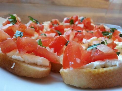 two slices of bread with tomatoes on a plate at Hotel Gasperin Bohinj in Bohinj