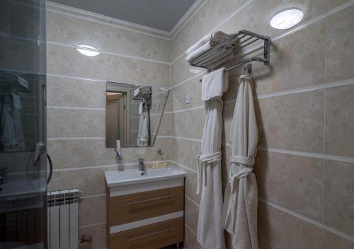 a bathroom with a sink and a shower curtain at PARK HOTEL Uralsk in Uralsk