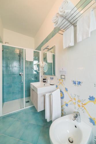a bathroom with a sink and a shower at Hotel Corallo Circeo in San Felice Circeo