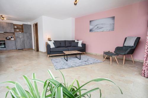 a living room with a couch and two chairs at Ferienwohnungen "Zur Wally" in Garmisch-Partenkirchen